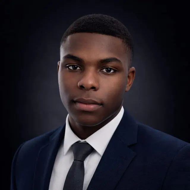 Studio portrait of Ojo Israel Ayomide in a navy suit